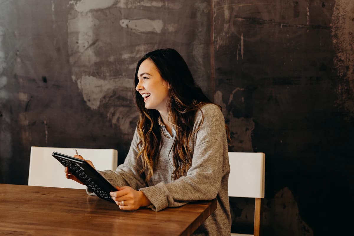 Creator laughing while reviewing content on a tablet